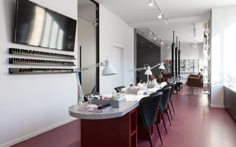 Beauty salon, no people. Interior of empty modern nail salon. Workplaces for masters of manicure. Pedicure cabinet.